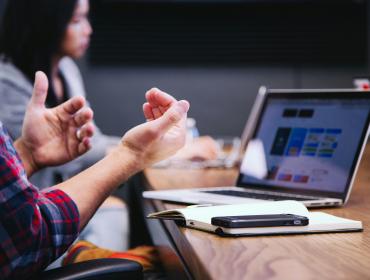 Person using a laptop for a meeting